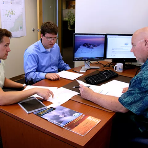 BSEE General Engineer Kyle Monkelien discusses the BSEE Alaska Region oil and gas program during a mentoring session with Grant Cummings (left) and Kyle Jones.