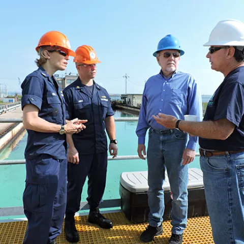 Bureau of Safety and Environmental Enforcement (BSEE) Oil Spill Response Division Chief David Moore, along with U.S. Coast Guard (USCG) Office of Marine Environmental Response Policy Chief Captain Claudia Gelzer and Lieutenant Commander Wes James, viewed a 42-foot long skimming vessel test, the first-of-its-size at Ohmsett, BSEE